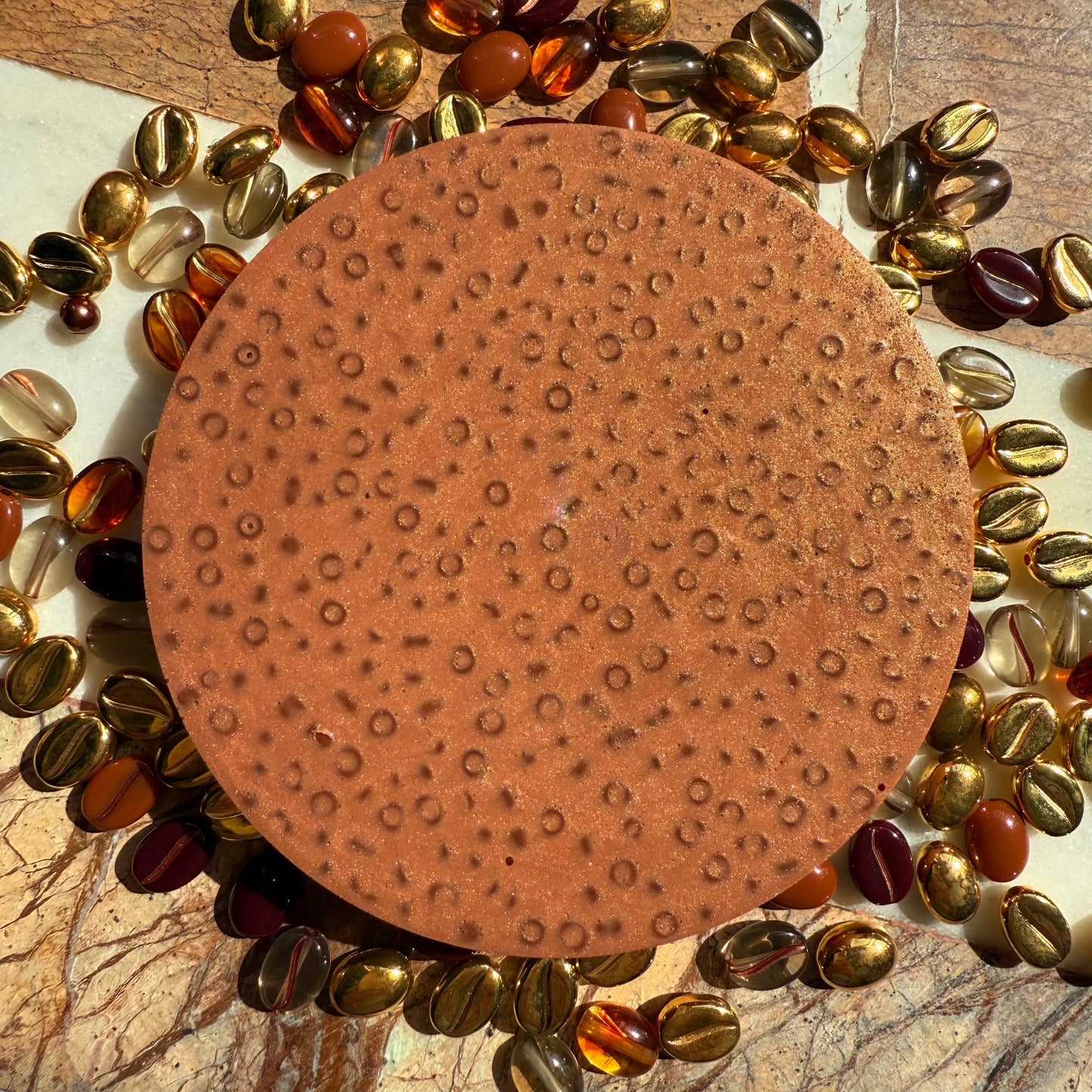 Close up of textured beads in remeltable coffee picky pad sensory toy