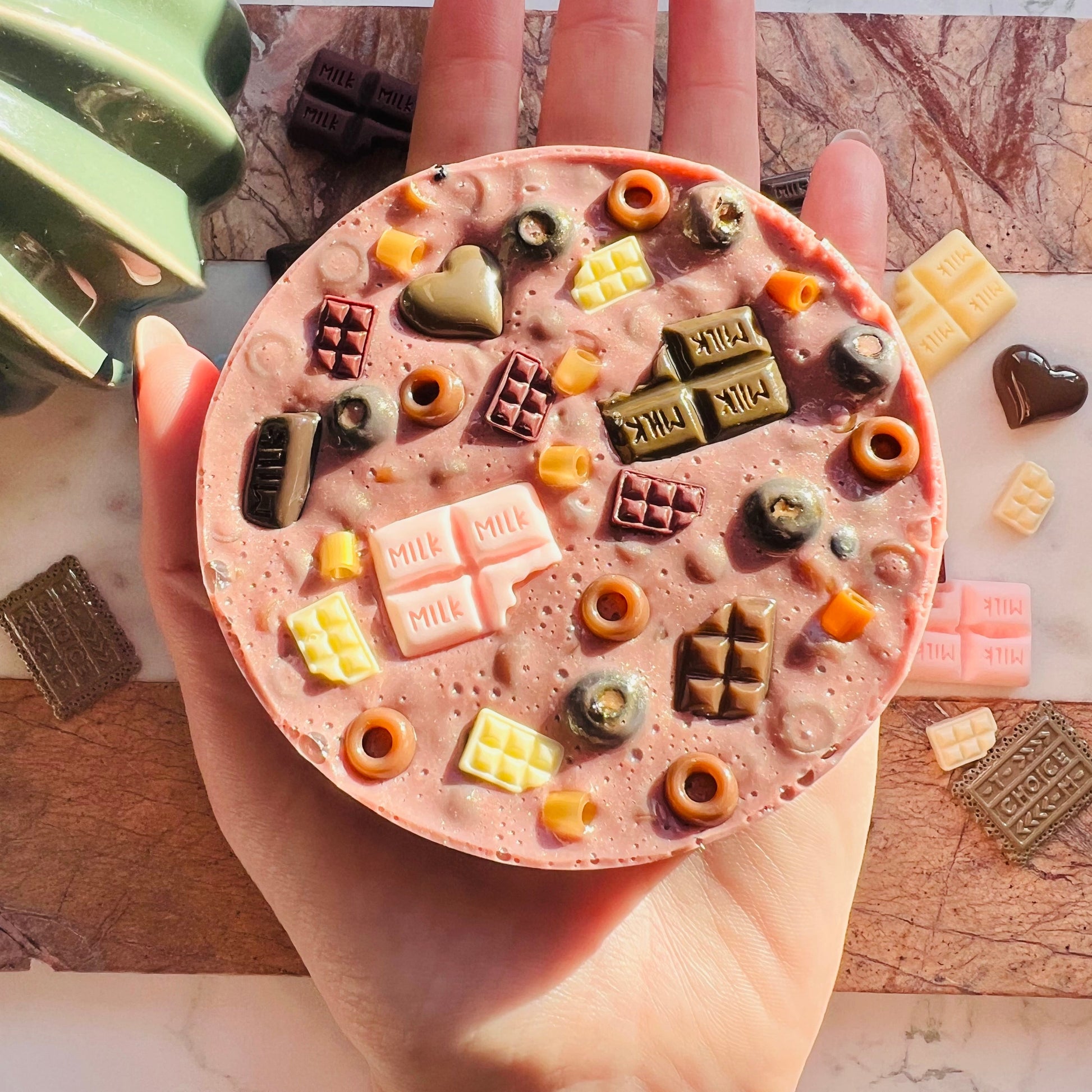 10cm chocolate picky pad sensory toy shown in hand for size reference