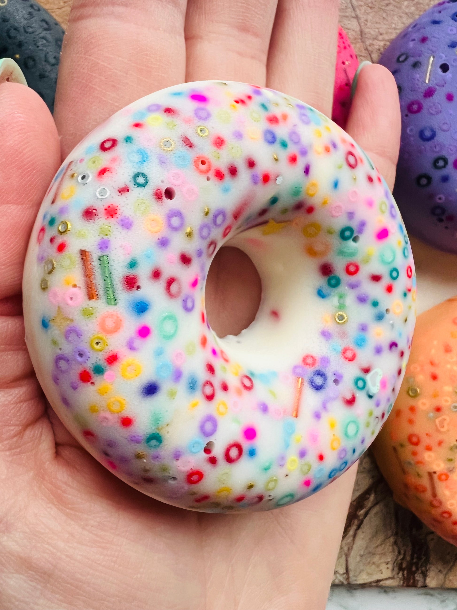7.5cm doughnut picky pad sensory toy shown in hand for size reference