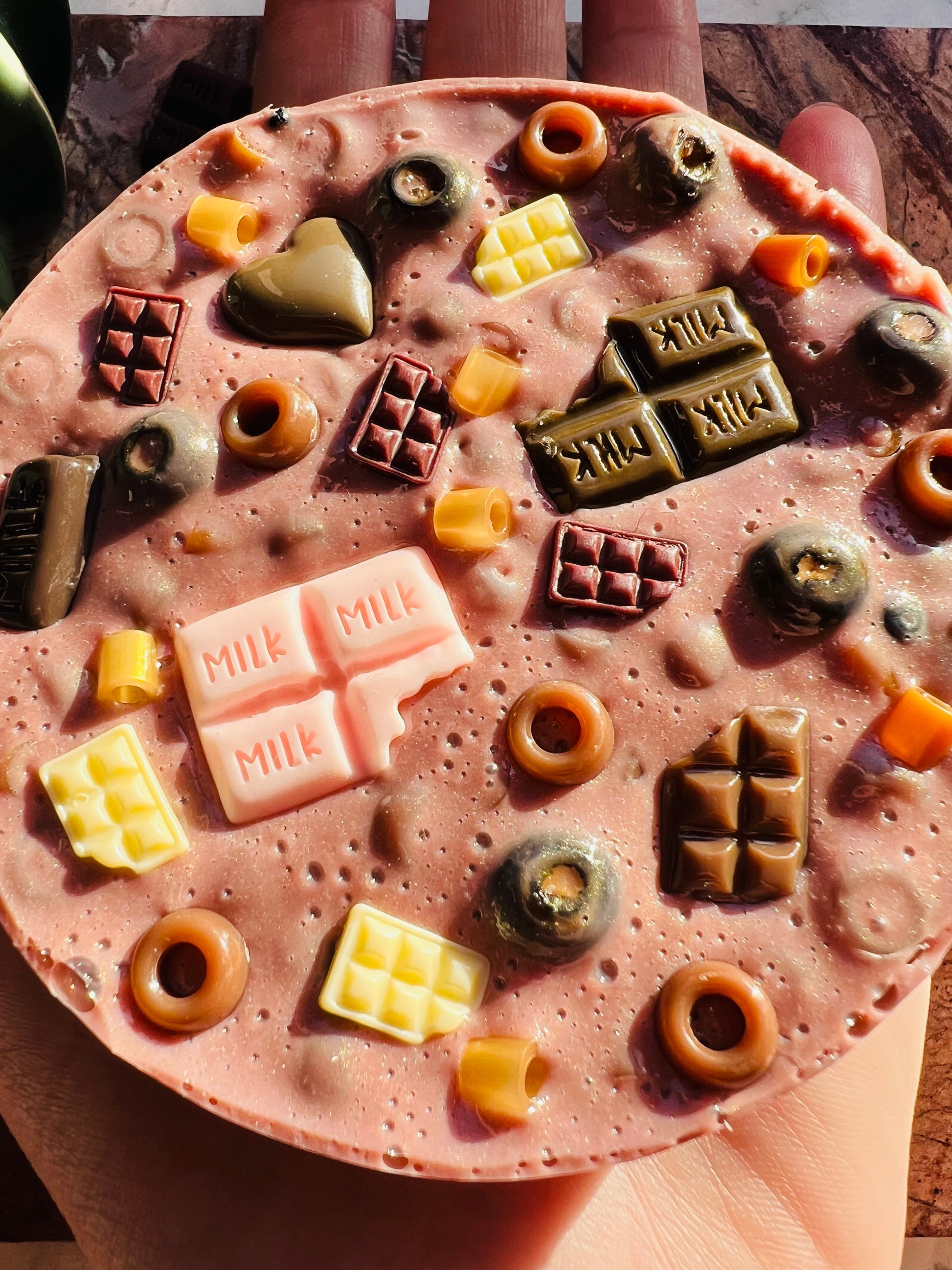 Close up of textured beads in remeltable chocolate picky pad