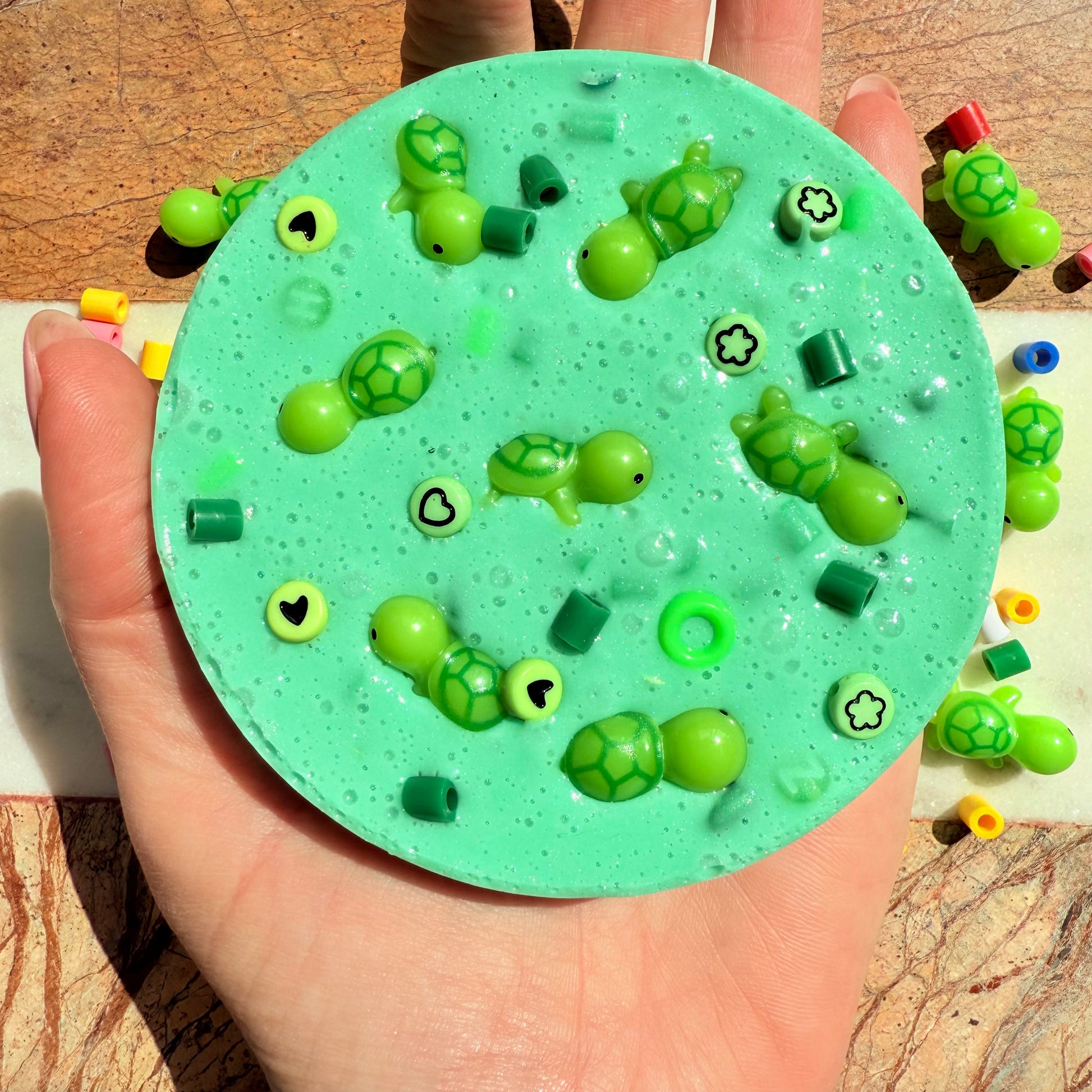 10cm turtle picky pad sensory toy shown in hand for size reference