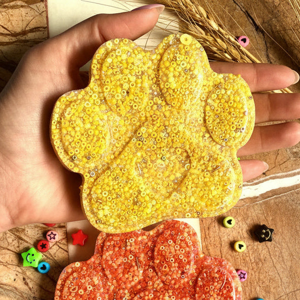 Large yellow paw picky pad sensory toy shown in hand for size reference